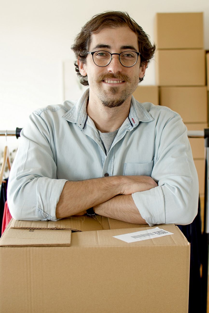 Online store owner with packed orders in his studio